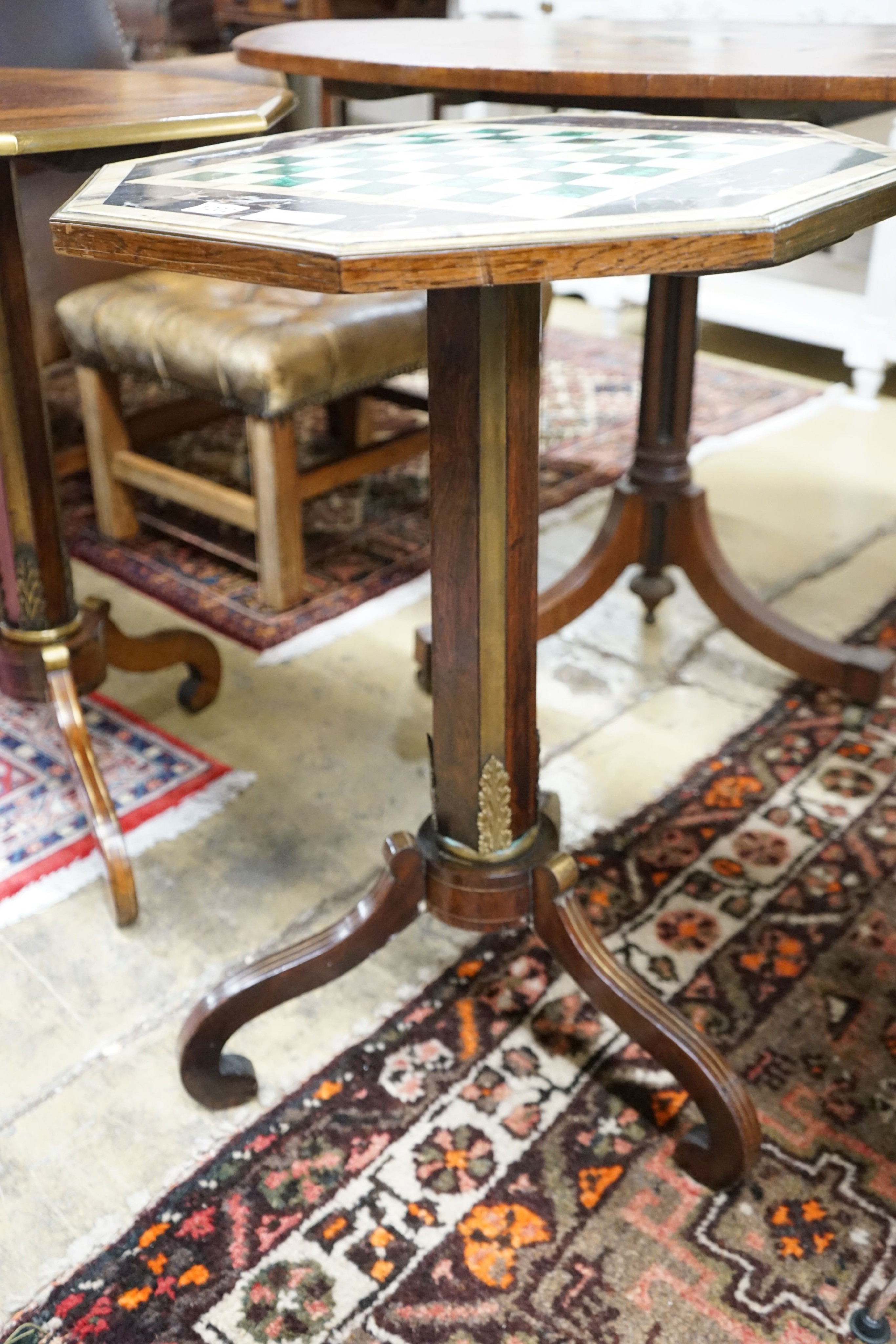 A Regency style brass mounted octagonal rosewood and specimen marble games table, width 49cm, height 70cm